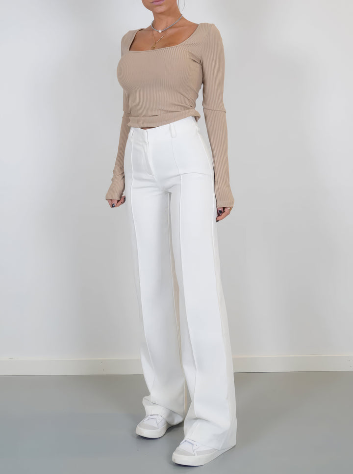 Woman wearing white wide-leg trousers