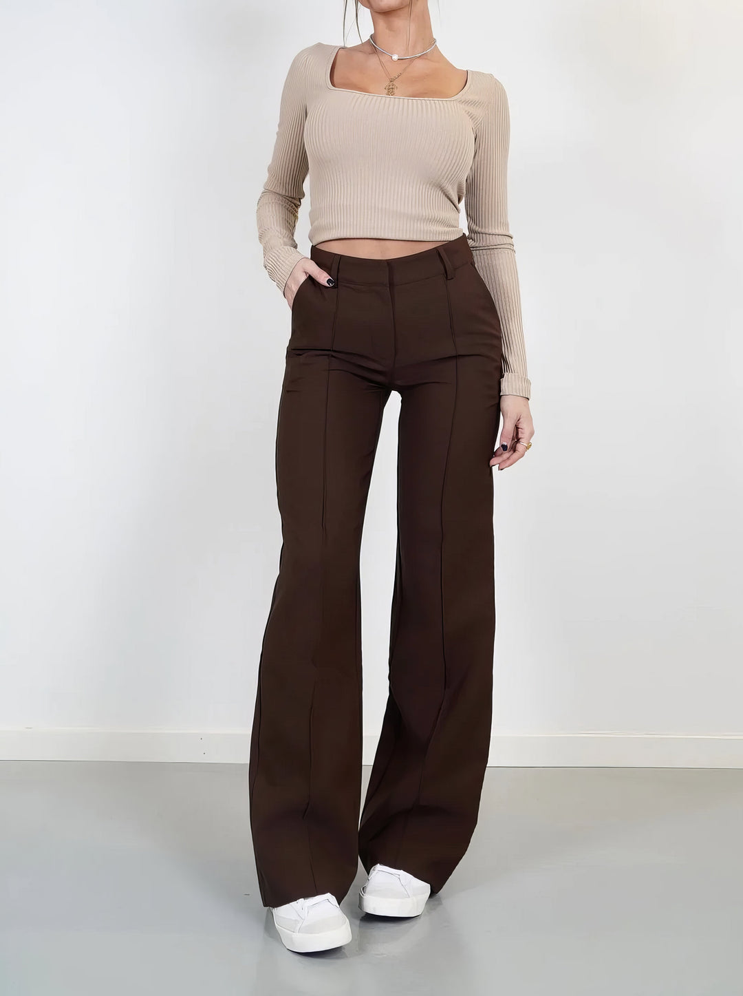 Side view of women's fashionable wide leg trousers with pleated detail