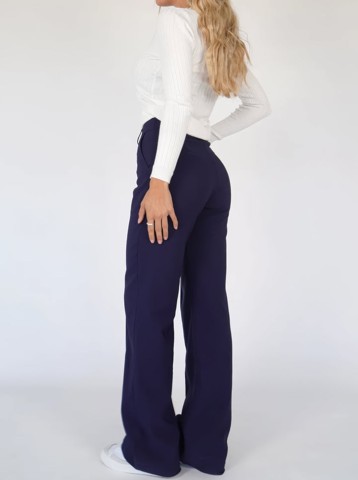 Close-up of fabric and waistband on women's elegant trousers