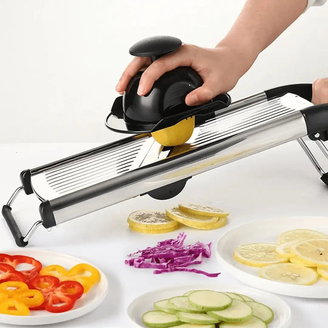 Demonstration of stainless steel mandoline slicing a lemon with a hand guard