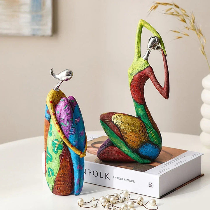 Two abstract modern decorative sculptures placed on top of a book as home decor