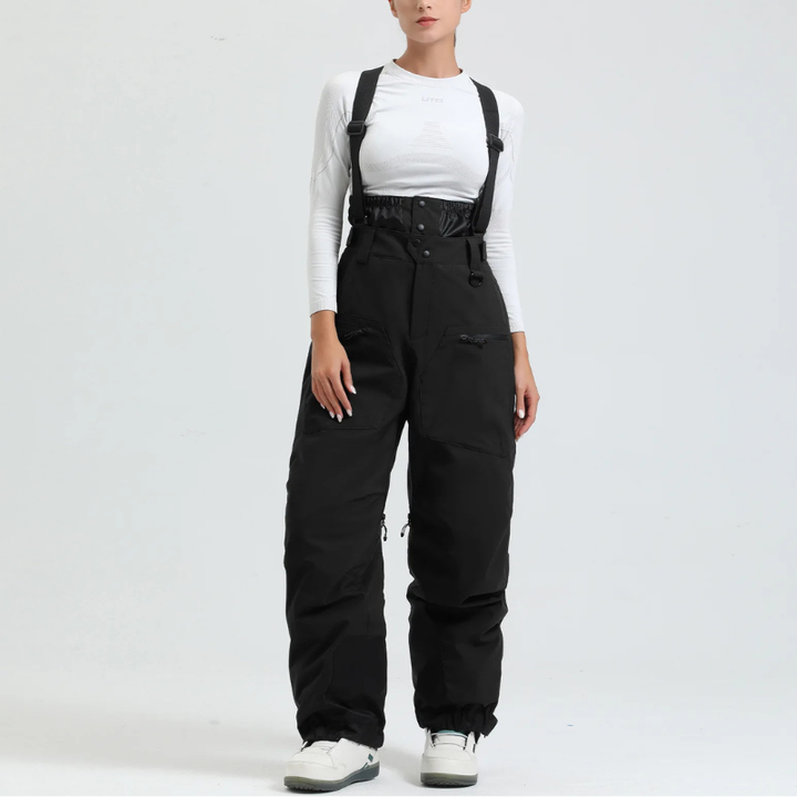 Close-up view of black snow trousers featuring multi-pocket design and high waist