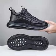 Detailed close-up of black mens trainers showing upper material texture