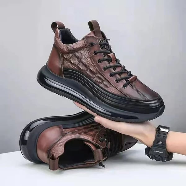Brown men's luxury air cushion trainers Mason held in hand