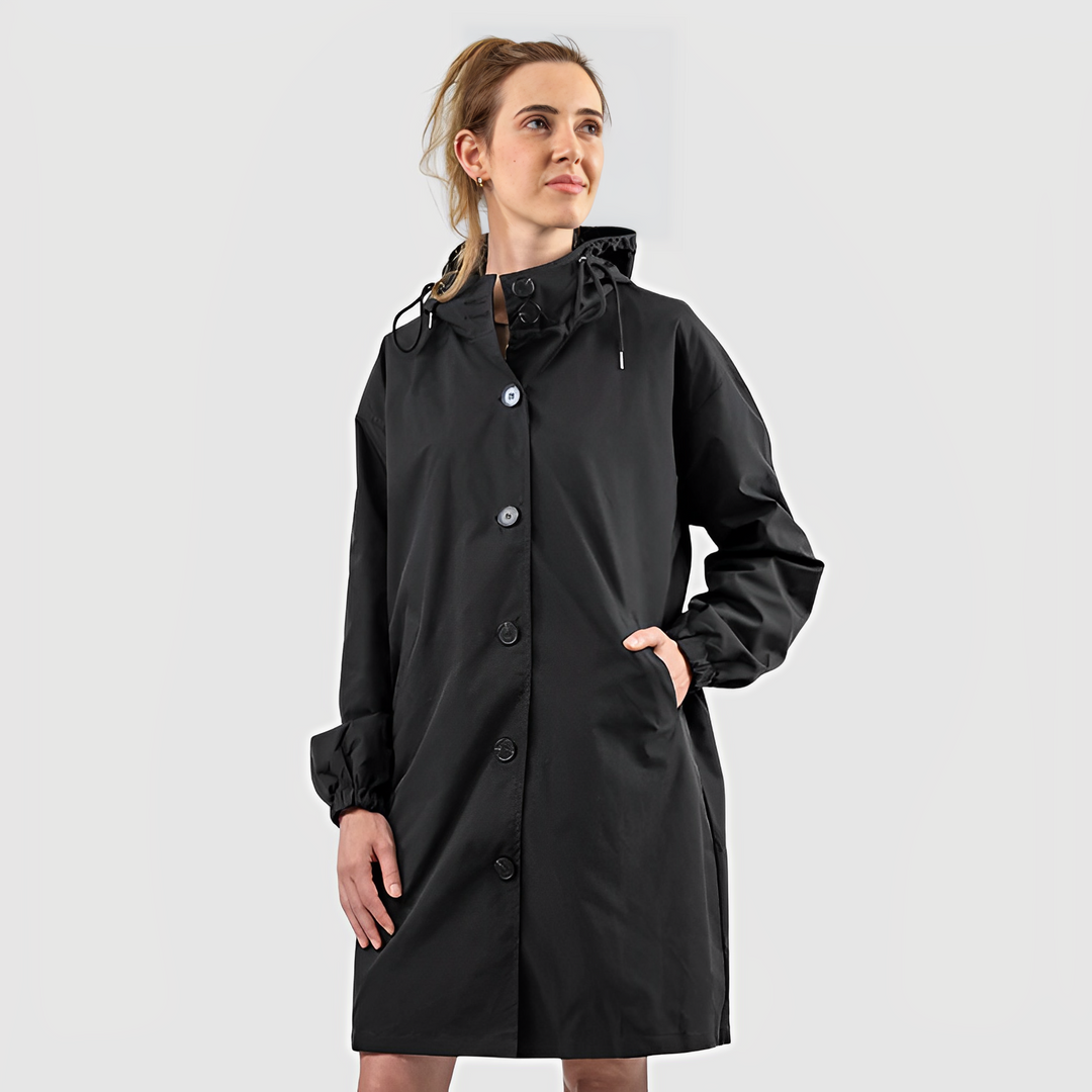 Woman wearing a black waterproof lightweight hooded rain jacket outdoors
