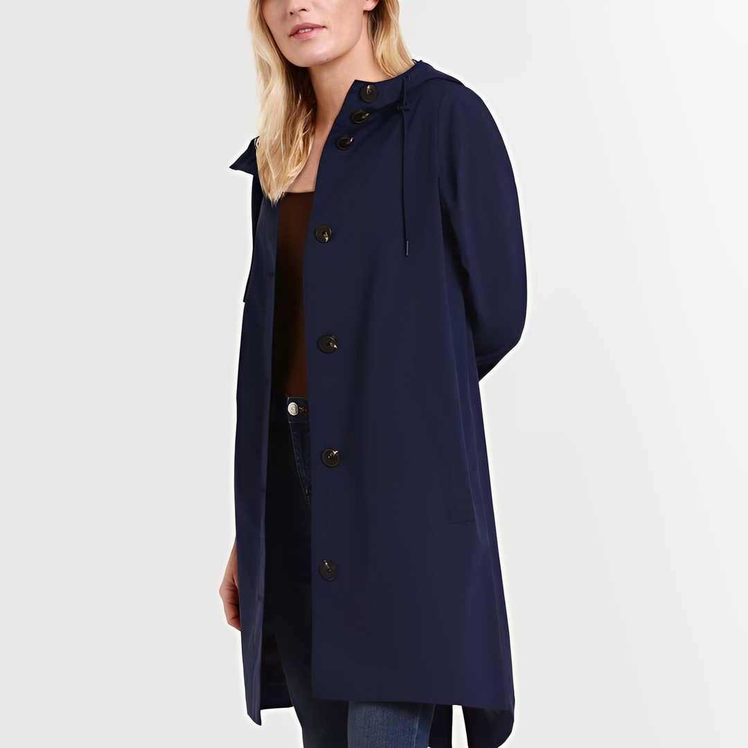 Woman wearing a dark blue waterproof hooded rain jacket with buttons