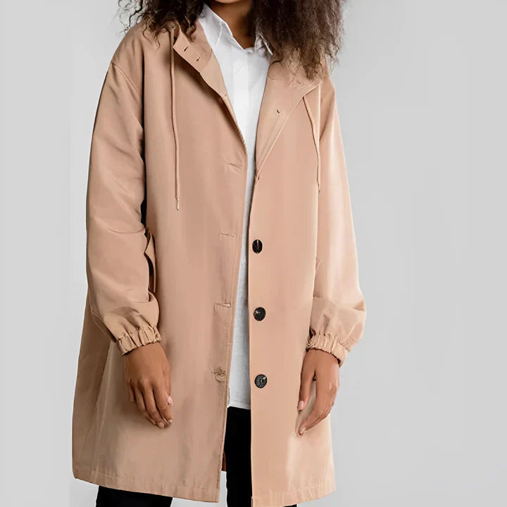 Woman wearing a khaki waterproof hooded rain jacket with a shirt