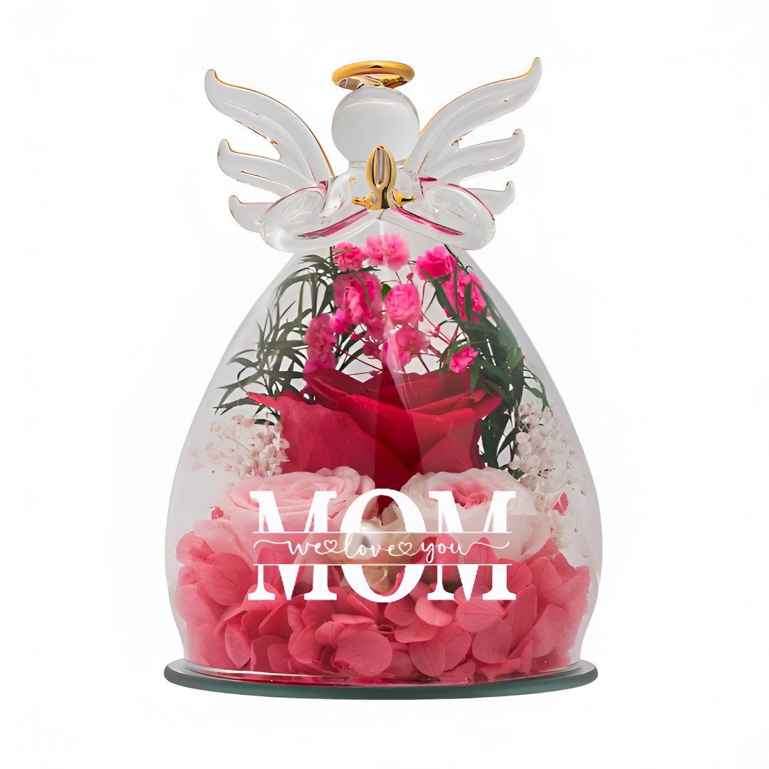 Preserved rose glass angel figurine displayed on a wooden surface in a lit room