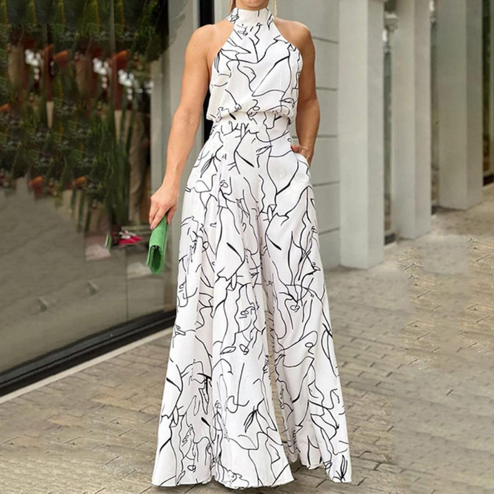 Model wearing white and black patterned sleeveless wide-leg jumpsuit