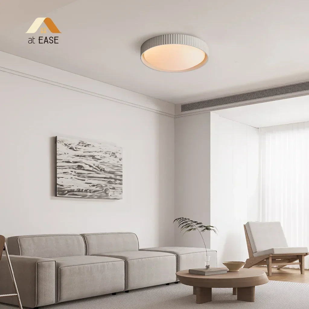 Architectural shot showing the sleek profile of the concrete flush mount lamp