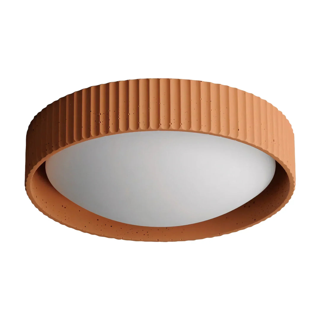 Argo concrete flush mount ceiling light turned on in a dimly lit room