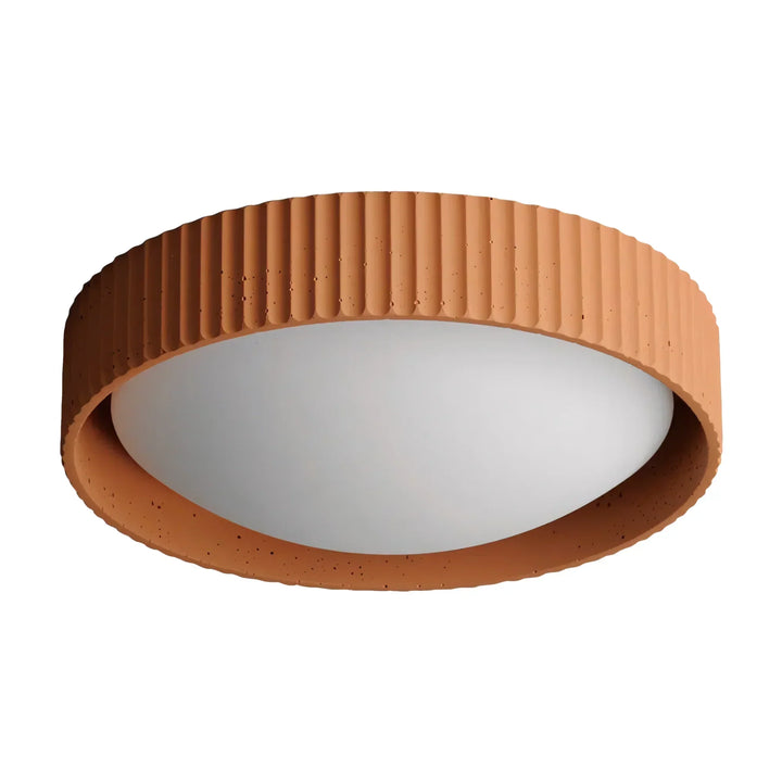 Argo concrete flush mount ceiling light turned on in a dimly lit room