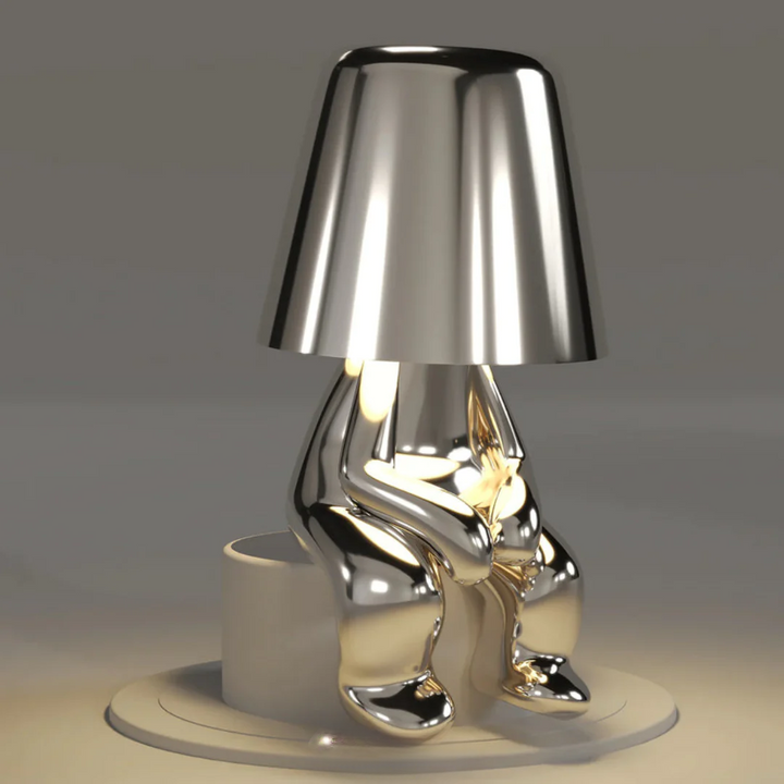 Stylish home decor touch lamp styled on a bookshelf with green plants