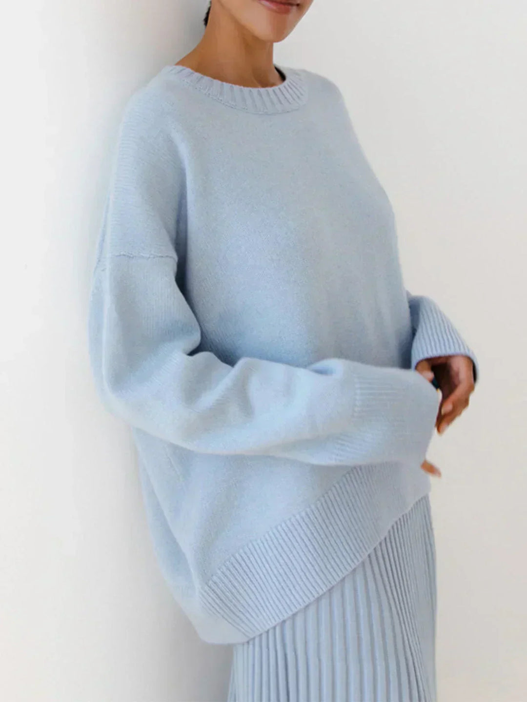 Model wearing light blue relaxed fit oversized sweater