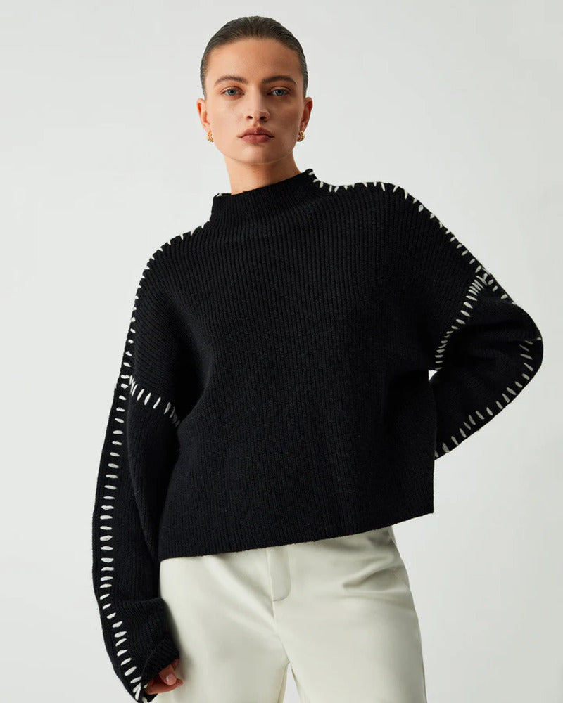 Close-up detail of soft black knit fabric on women's winter sweater