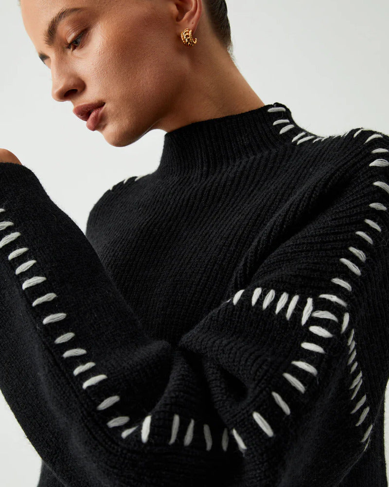 Back view of women's classic black mock neck oversized pullover sweater
