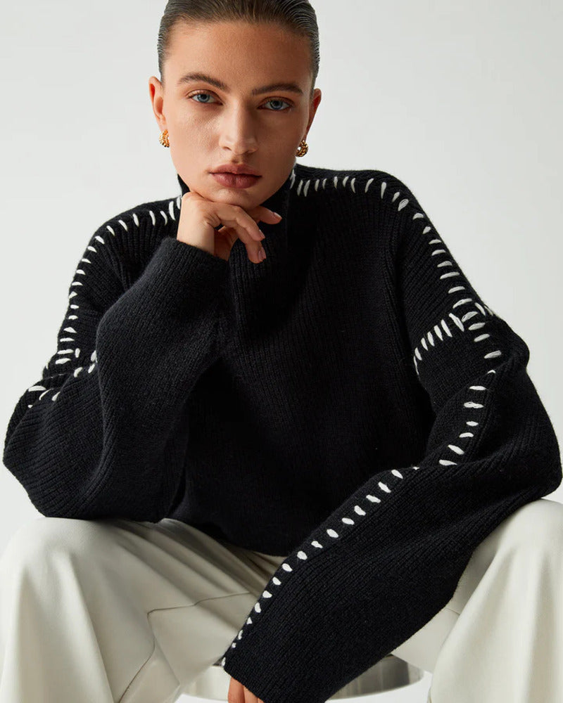Close-up of a woman in a black mock neck sweater posing