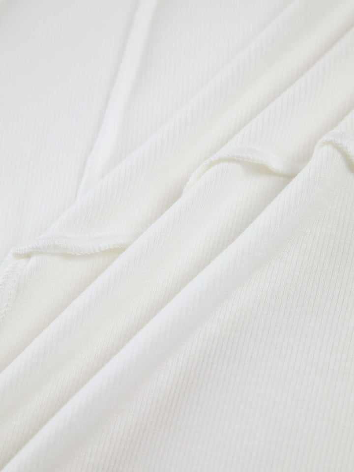 Close-up view of soft ribbed fabric and delicate piping detail