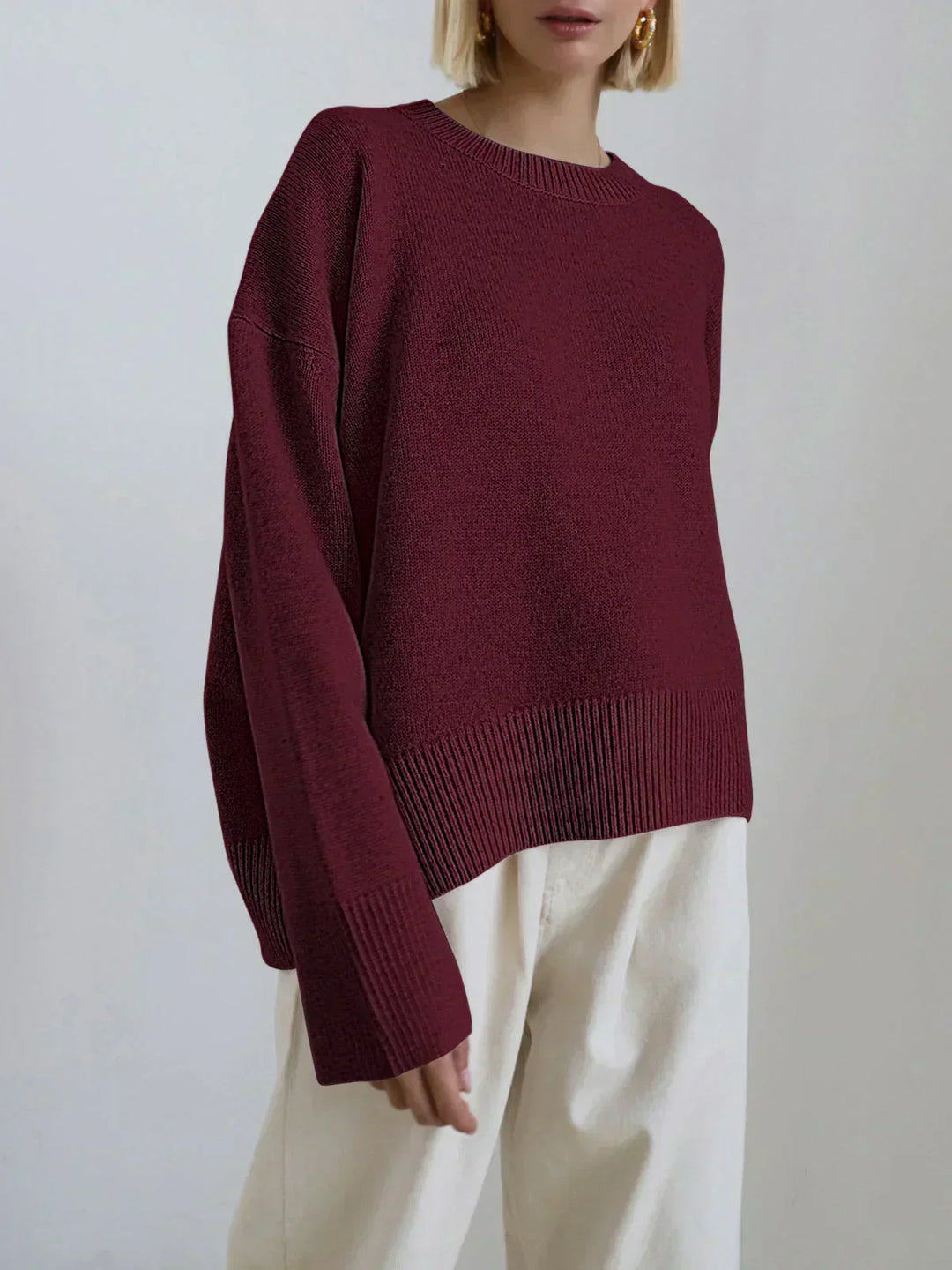 Model wearing burgundy oversized sweater with skirt