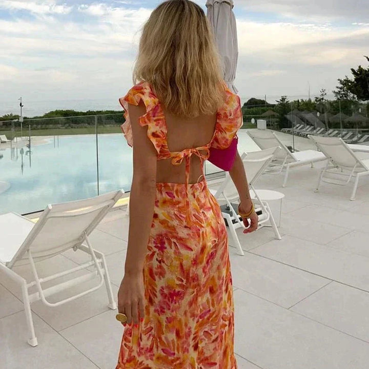 Back view of a woman in a floral long summer dress with ruffle details