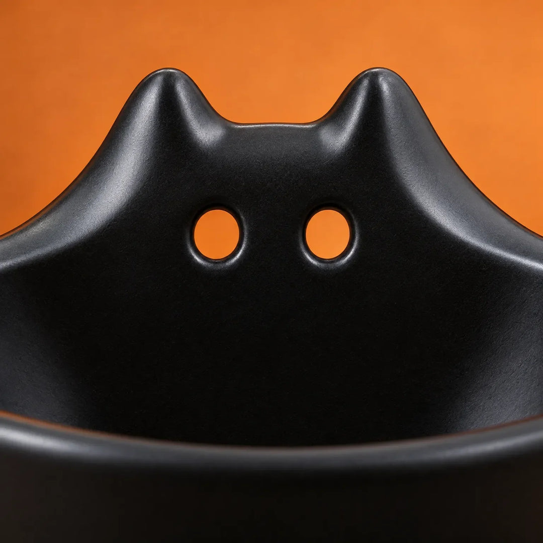 Matte black bat dish holding autumn treats as seasonal home decor