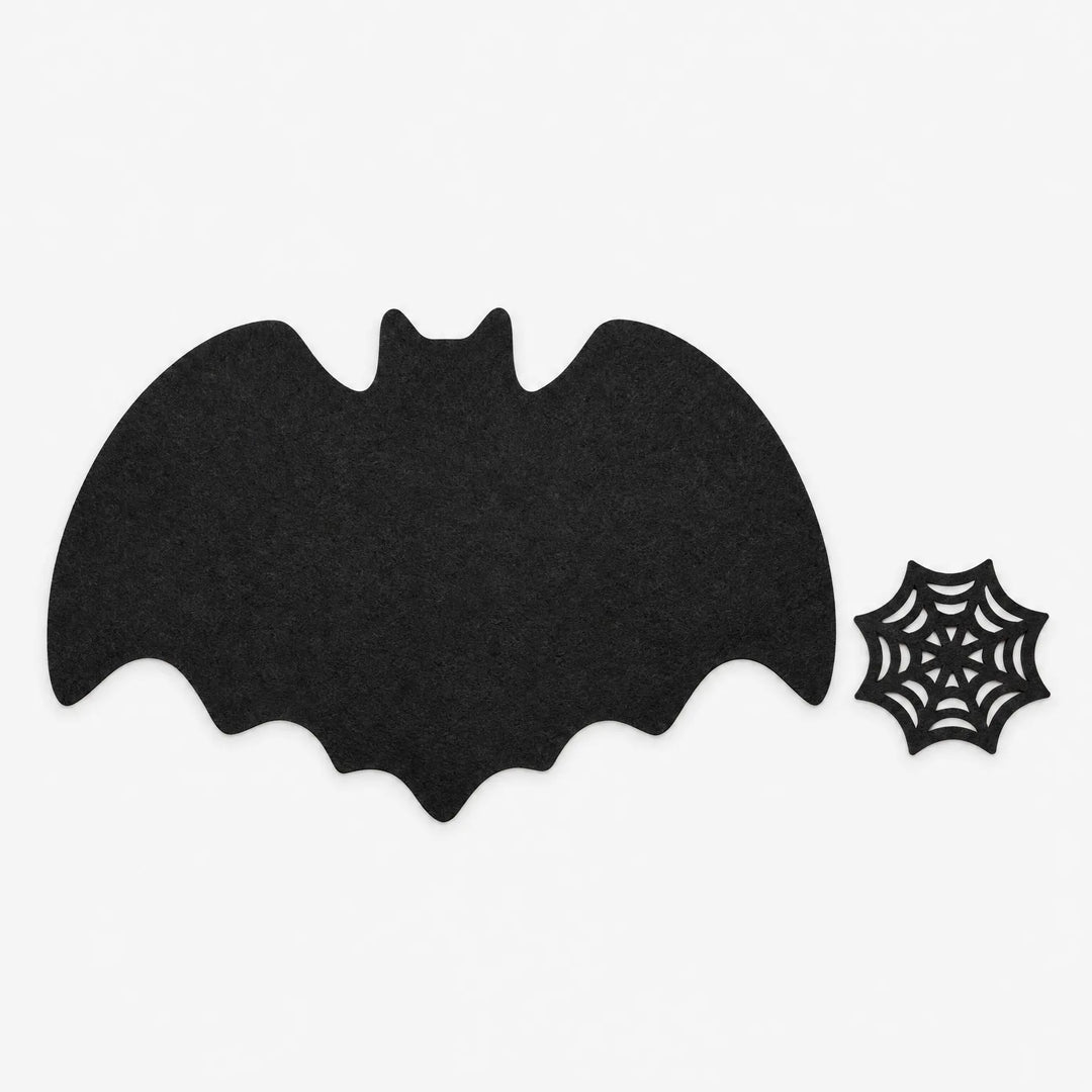 Black bat shaped Halloween placemats set styled on a gothic dining table decor setup