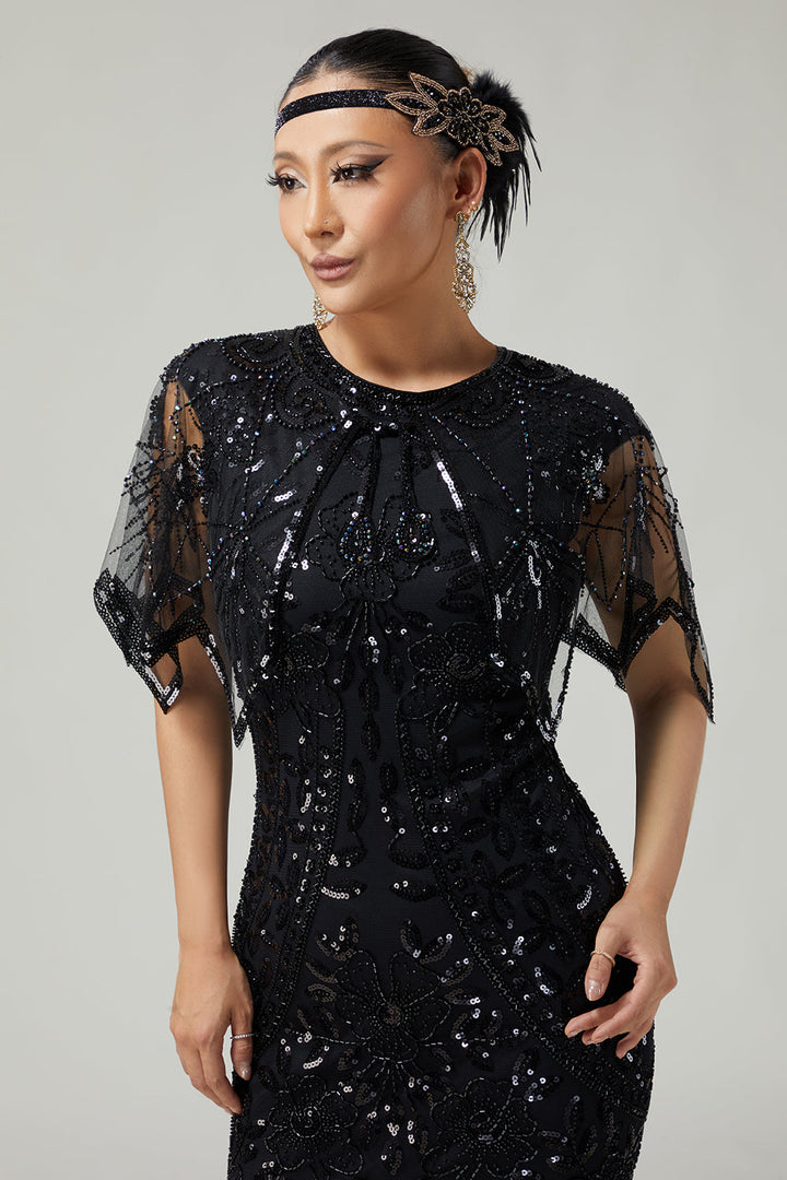 Close-up front view of embroidered sequin and bead pattern on evening capelet