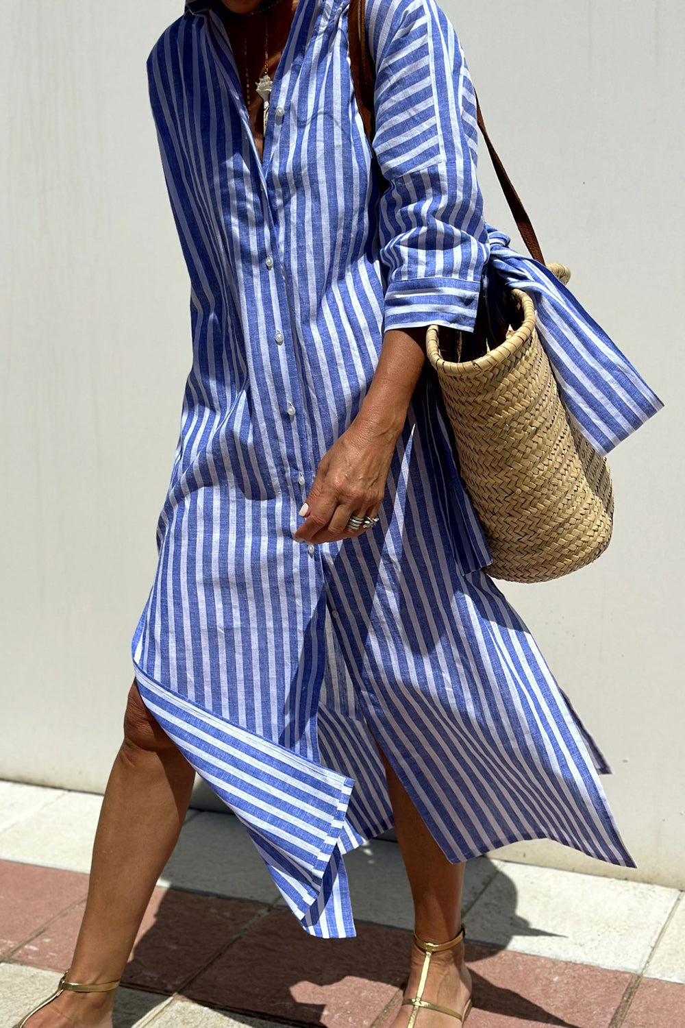 Close-up of fabric and buttons on casual striped midi dress for women