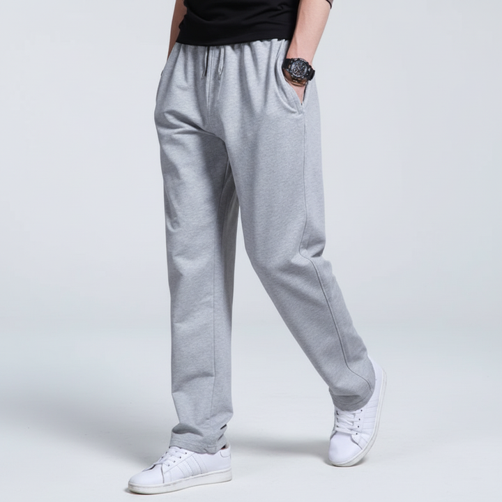 Close-up of ribbed ankle cuffs on mens black sporty joggers and sweatpants