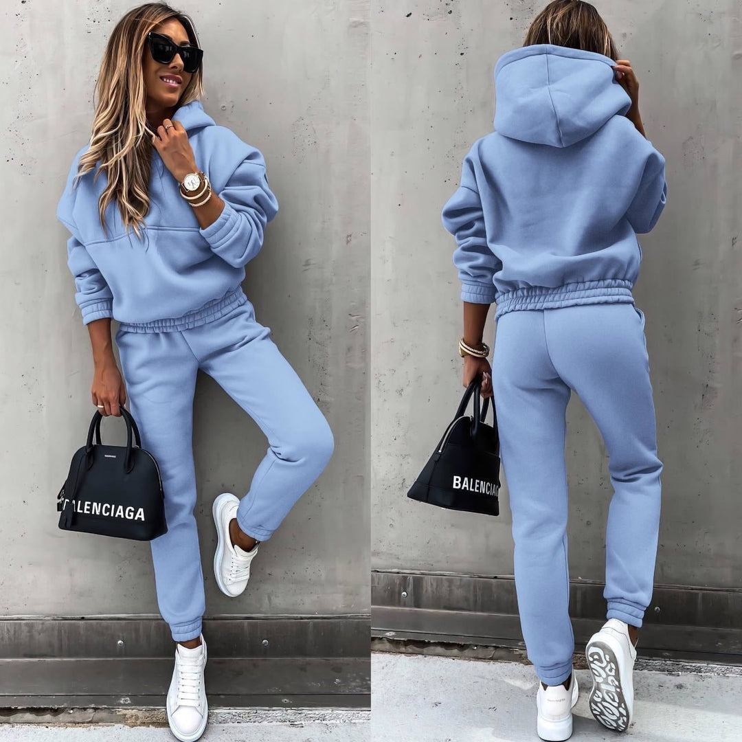 Woman wearing a soft blue jogging set with matching hoodie and trousers while posing outdoors