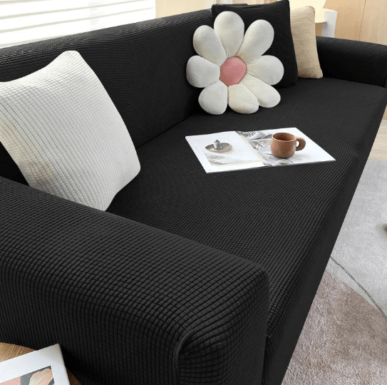 Universal non-slip sofa cover protecting a living room couch against stains and wear