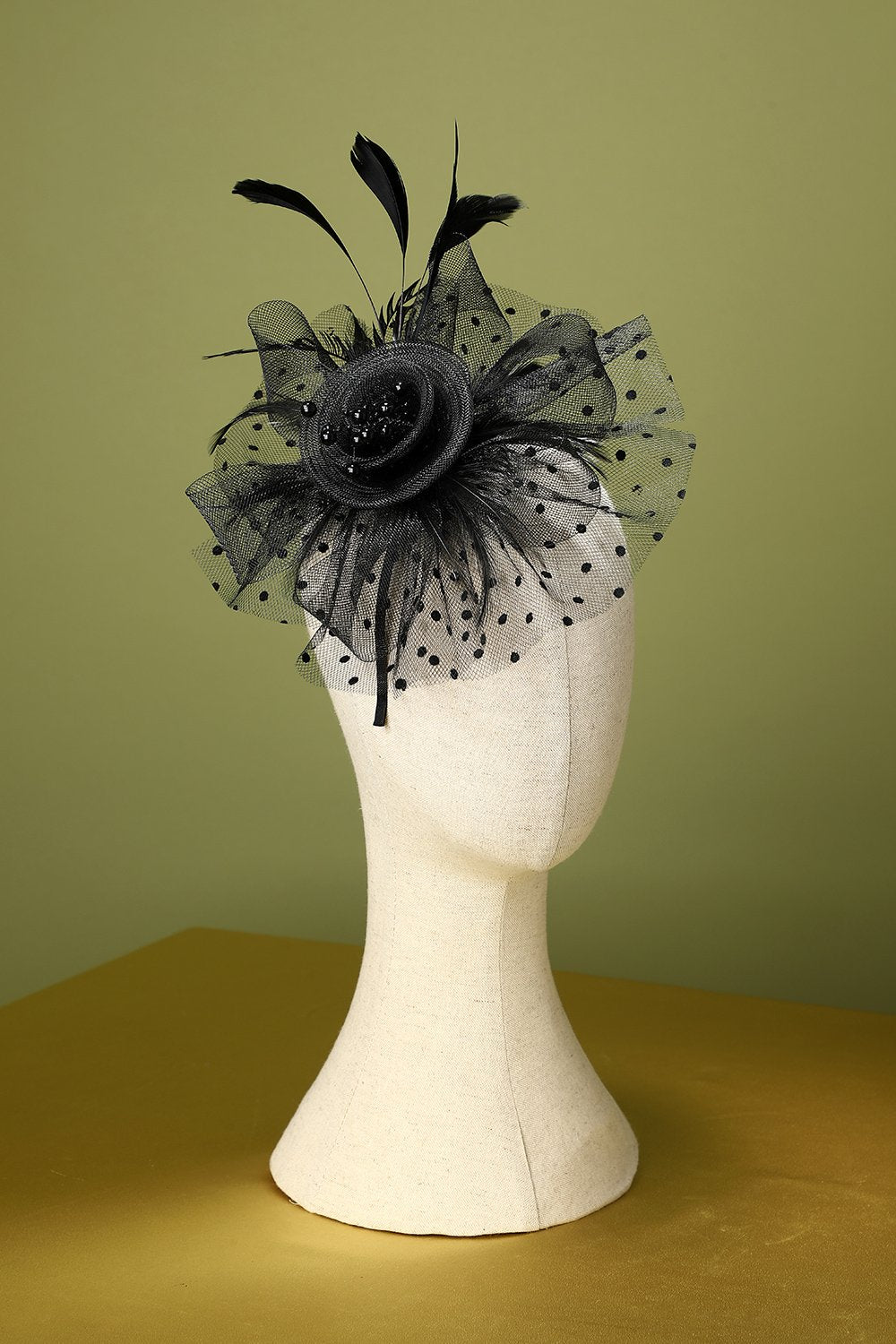 Black floral ladies fascinator headband displayed on mannequin head