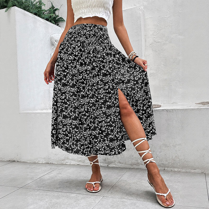 Model wearing black floral split midi skirt with strappy sandals