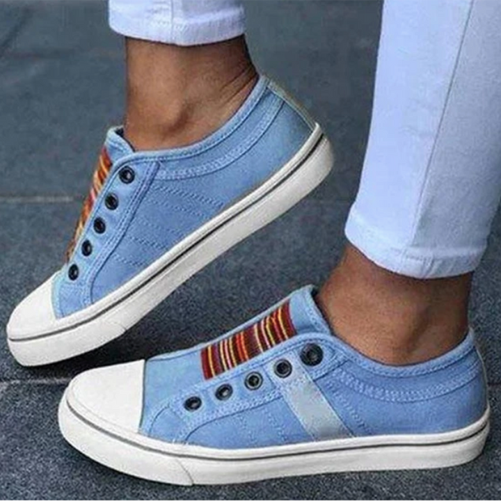Light blue women's slip-on sneakers with decorative striped elastic detail