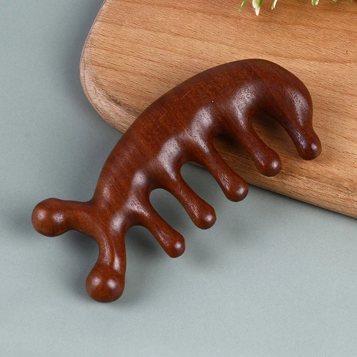 Top angle view of the curved wooden hair and scalp massage comb