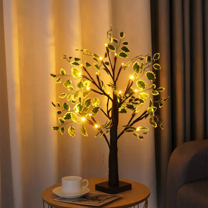 Black glowing tree table lamp casting warm LED light on a side table