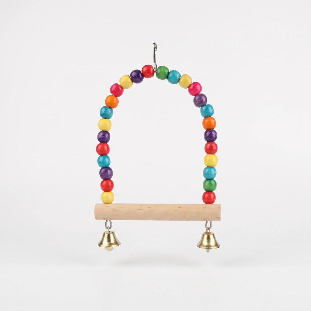 Colourful wooden bird swing with hanging bells and multi-coloured beads on a white background