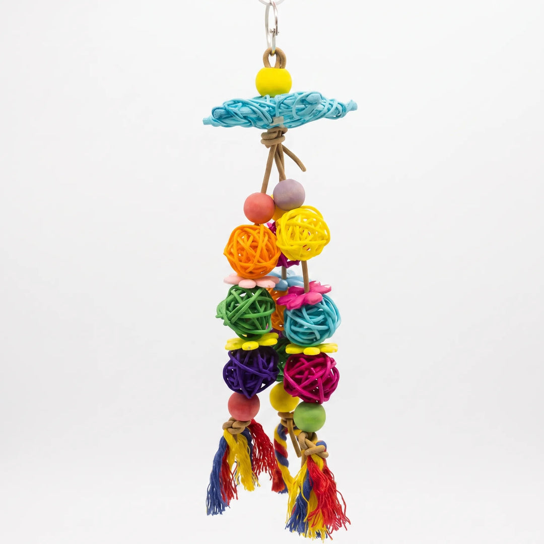 Colorful hanging bird toy with woven rattan balls and wooden beads on a white background