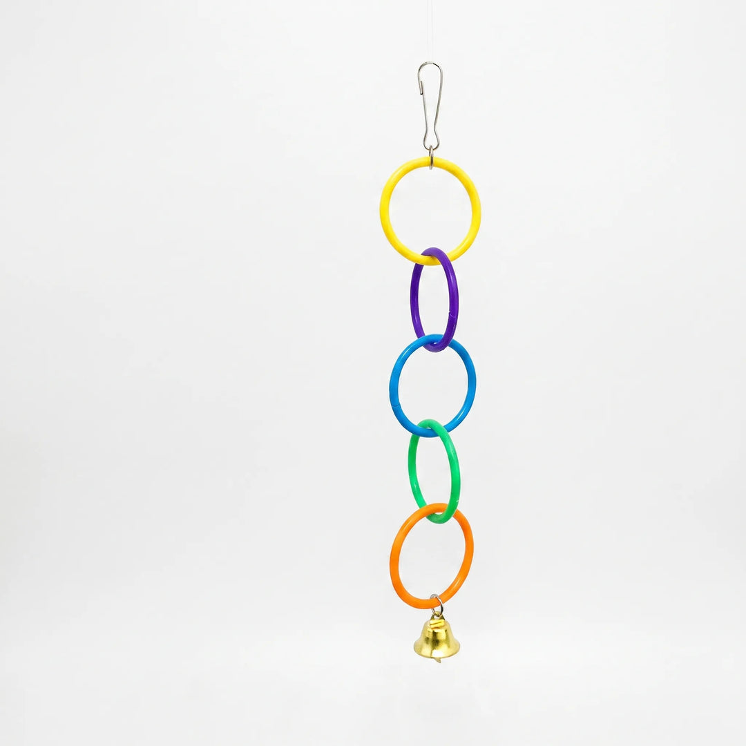 Colourful bird toy with interlocking plastic rings and metal bell on white background