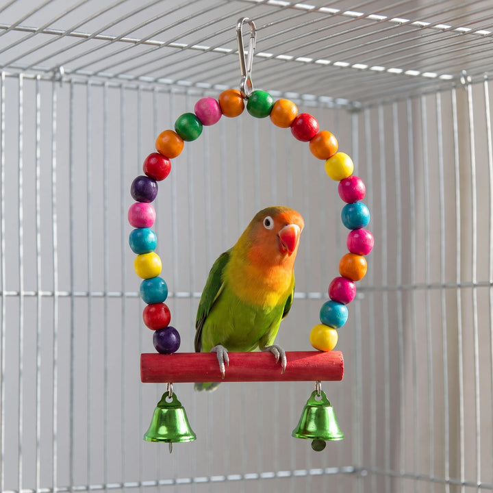 Colorful wooden ring swing toy hanging inside a bird cage with a lovebird