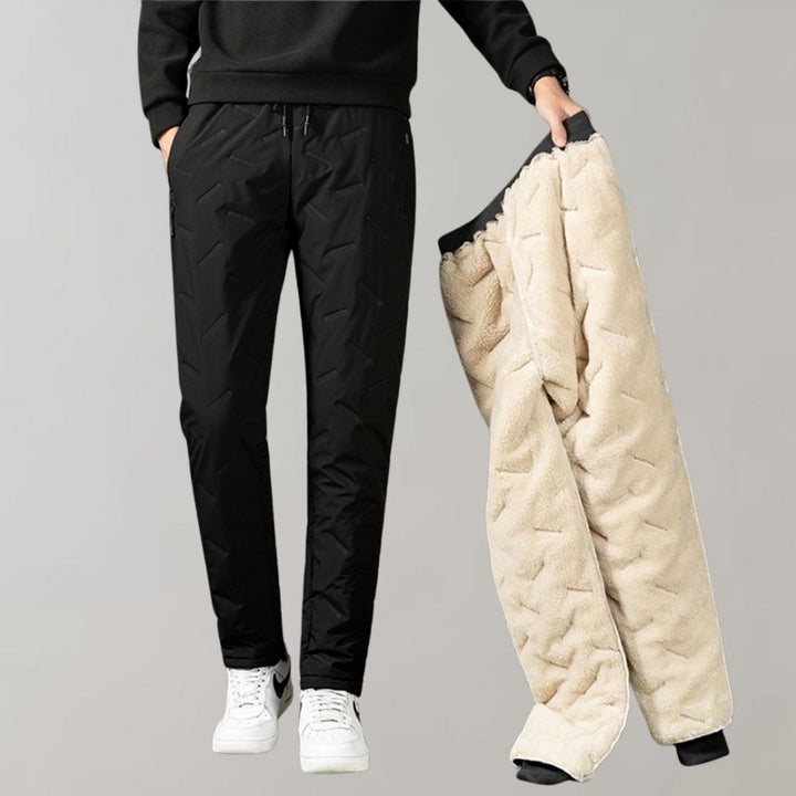 Man wearing black winter trousers showing thick inner lining