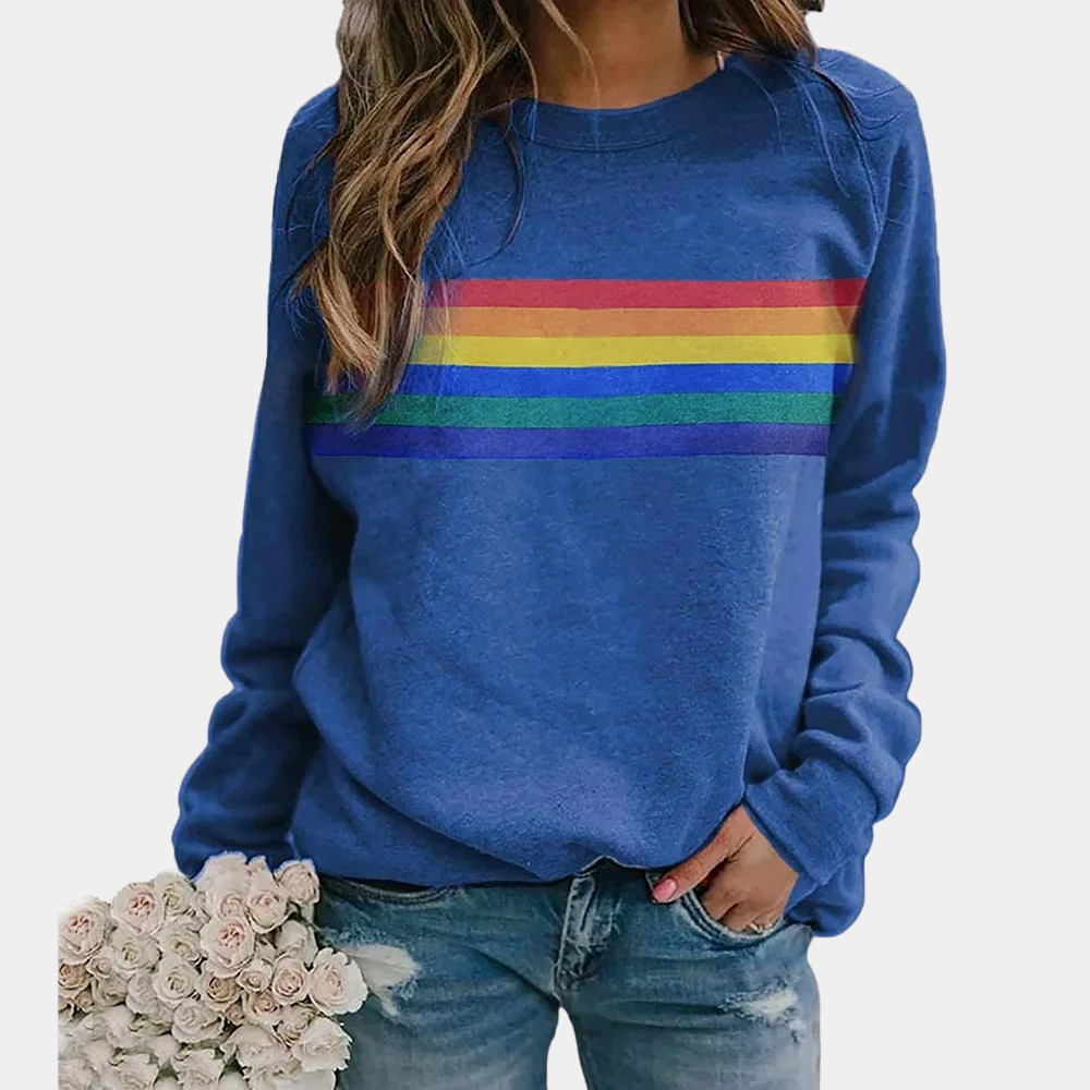 Woman wearing blue rainbow stripe crewneck sweatshirt with distressed jeans