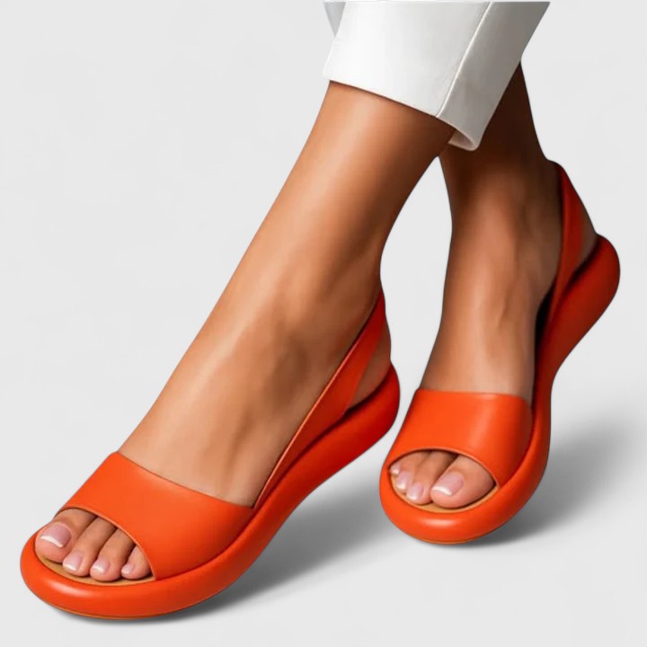 Close-up of vibrant orange peep toe slingback flatform sandals