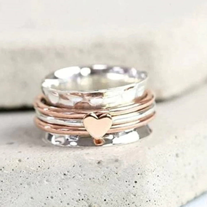 Silver womens heart spin ring styled as a stacking ring for women