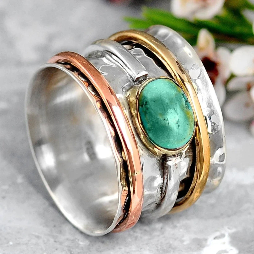 Close-up shot of the vintage turquoise statement ring showcasing silver and gold bands