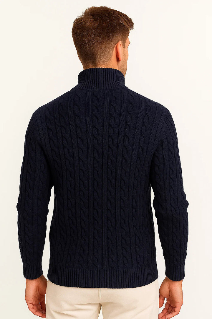 Back view of a man wearing a dark blue quarter zip cable knit jumper