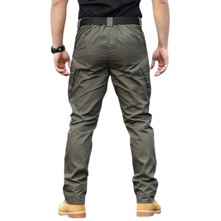 Back view of a man wearing green tactical outdoor cargo trousers showing rear pockets