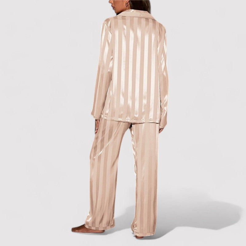 Woman wearing beige satin stripe pajama set back view