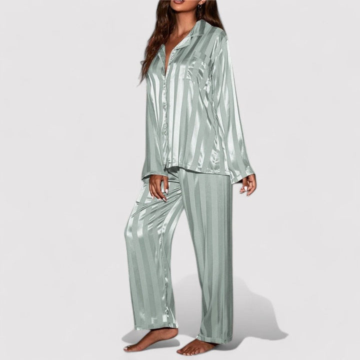 Woman wearing green satin stripe pajama set side view