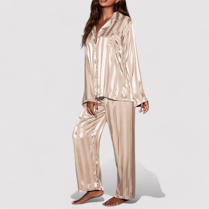Woman wearing beige satin stripe pajama set side view